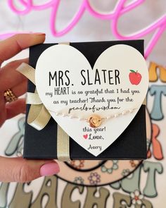 someone is holding up a card that says, mrs slater my heart is so grateful that i had you as my teacher thank you for the greatest gift