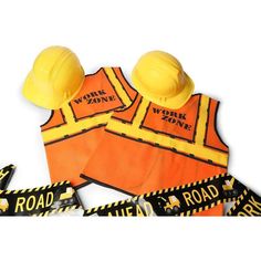 three safety vests with yellow hard hats on top of them and road work zone stickers