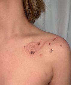 a woman's chest with stars and planets on it