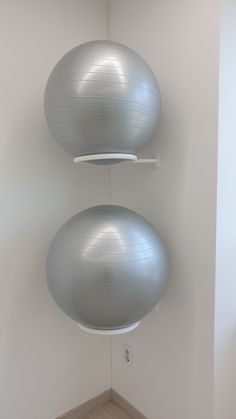 there are two large gray balls hanging from the ceiling