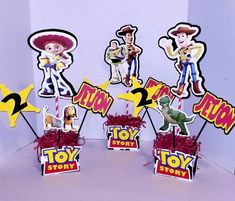 toy story centerpieces are displayed in front of a white background with red and yellow decorations