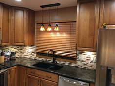 a kitchen with wooden cabinets and stainless steel appliances