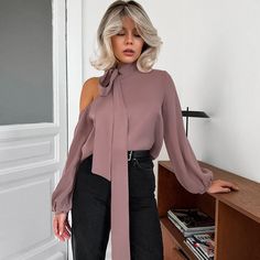 Made from 100% polyester, this women's satin asymmetrical neckline sexy off-shoulder long sleeve shirt offers ultimate comfort and a silky touch. The asymmetrical neckline design paired with an off-shoulder look adds a touch of sexiness and fashion. Decorative satin ribbons enhance the overall sophistication and elegance of the shirt. Whether for everyday wear, casual outings, vacations, or office commutes, this shirt is easy to style. Suitable for spring, summer, and autumn, it is a must-have i