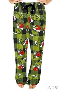 a person wearing green pants with red and black designs on it's legs, holding their hands out to the side