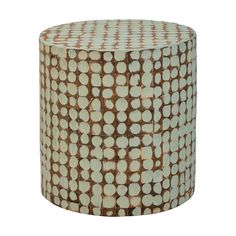 a brown and white patterned stool with dots on the top, sitting in front of a white background