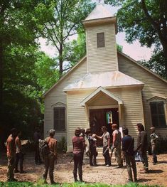 a group of people standing in front of a church