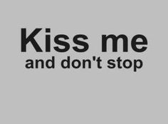 the words kiss me and don't stop are in black on a gray background