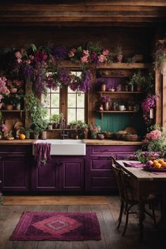 a kitchen with purple cabinets and lots of flowers on the counter top, along with a rug