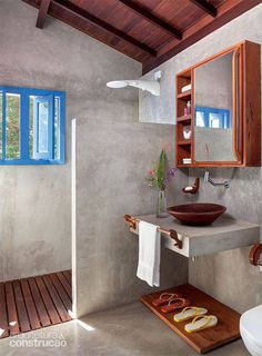 a bathroom with a sink, mirror and towel rack on the wall next to it