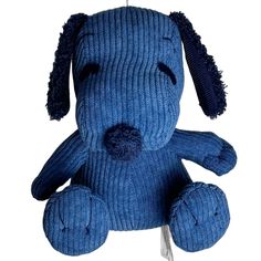 a blue dog stuffed animal hanging from a hook on a white background with the tag attached to it's ear