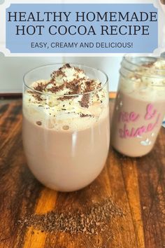 two glasses filled with hot cocoa drink on top of a wooden table