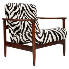 a zebra print chair with wooden frame