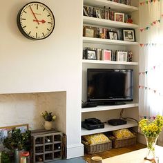 a living room filled with furniture and a large clock on the wall