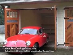 a red car parked in front of a garage