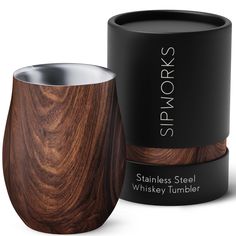 the stainless steel whiskey tumbler is made from wood and has a black box on it