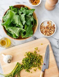 chopped green vegetables on a cutting board next to other ingredients