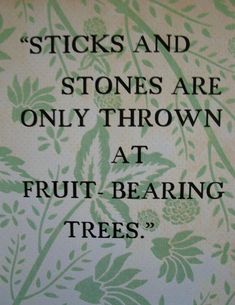 a quote on fruit bearing trees written in black ink with green leaves and pine cones