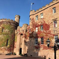 an old brick castle with ivy growing on it