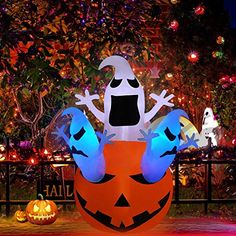 an inflatable pumpkin with a frog on it's back and two jack - o - lanterns behind it