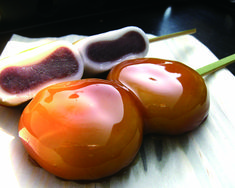 three cherry tomatoes sitting on top of a cutting board