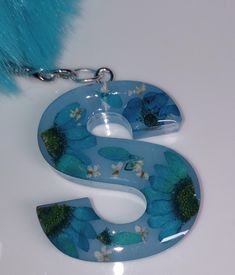 the letter s is decorated with blue flowers