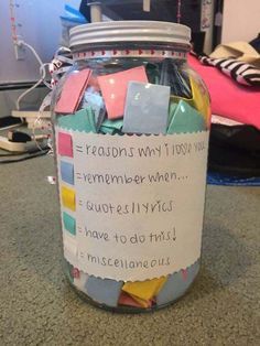 a jar filled with lots of different colored notes and paper stuck to the side of it