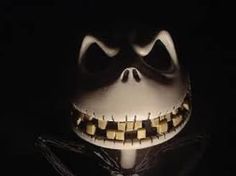 a creepy mask with teeth and gold chains on it's face in the dark