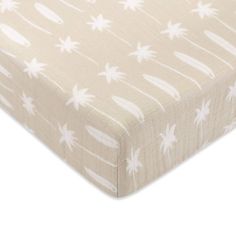 an image of a baby crib sheet with white stars and palm trees on it