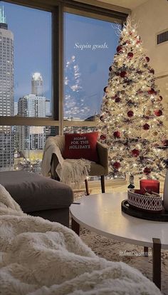 a living room filled with furniture and a christmas tree in front of a large window