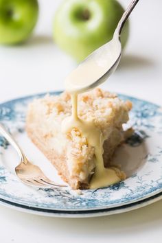 a piece of cake is being drizzled with caramel sauce on a blue and white plate