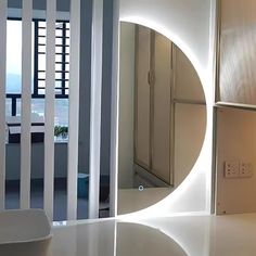 a bathroom with a circular mirror on the wall