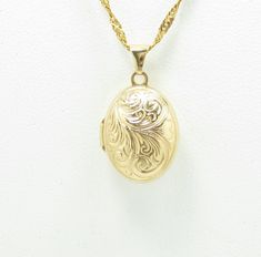 14k yellow gold .5" x .65" condition: excellent Dainty and sweet antique locket, crafted of 14 karat yellow gold.  The locket is  from the 1940s, and measures .5" wide and just under .75" high, not including the bail.  It has a rounded, oval shape, and is embellished with repousse period details on the front cover of the locket.  This locket is so lovely! The locket is in excellent condition inside and out, and has its original glass frames intact.  It tests as 14k gold and is guaranteed to be 1 Vintage 14k Gold Locket Necklace, Vintage 14k Gold Locket Necklace Stamped 14k, Ornate 14k Stamped Jewelry For Formal Occasions, Victorian Yellow Gold Locket Necklace For Formal Occasions, Vintage Gold Locket Necklace Stamped 14k, Elegant 14k Gold Locket Jewelry, Antique Yellow Gold Diamond Cut Necklace, Vintage Wedding Necklace With Polished Finish, Vintage Wedding Necklaces With Polished Finish