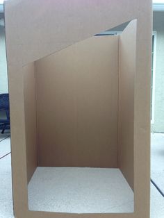 an open cardboard box sitting on the ground