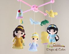 three little dolls hanging from the ceiling in a nursery or child's playroom