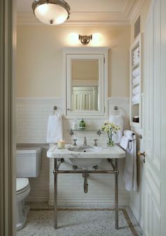 a bathroom with a sink, toilet and mirror