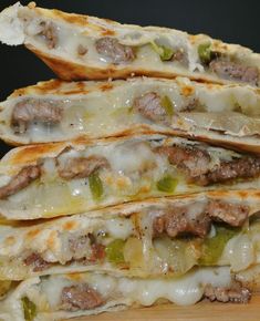 three quesadillas stacked on top of each other with cheese and meat in them