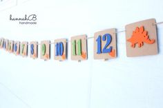 a wooden sign that says happy birthday hanging from a line with clothes pins and magnets