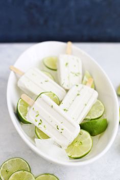 a white bowl filled with limeade popsicles