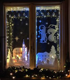 two windows decorated with christmas lights and decorations