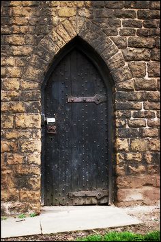 an old church door with a metal latch