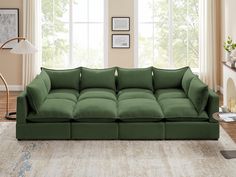 a living room with a green couch and two lamps on the side of the wall