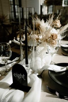 the table is set with black and white place settings