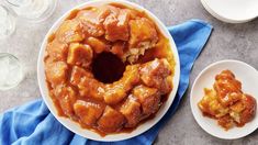 a bundt cake sitting on top of a white plate next to a blue napkin