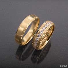 two gold wedding bands with diamonds on them