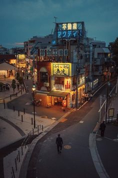 a man walking down the street at night