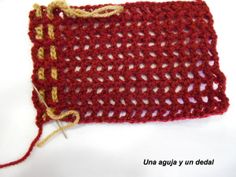 a red crochet bag with yellow thread on it and the bottom half is empty