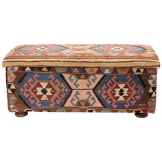 an old box with colorful designs on the lid and legs, sitting on a white background