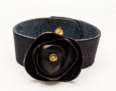 Trendy and chic, this beautiful cuff bracelet is handmade with genuine leather.  They make  perfect gifts for your female siblings: Christmas, Valentines day, Mother's day, birthdays, wedding anniversary.... or just because. Color : black  Size : Choose yours in the drop down menu. For any help you should send me a message. Care instruction : gently clean with soft and dry cloth. Avoid too much contact with water. This item is sent with tracking number 1 to 3 days after payment.  Happy shopping ! :) Find all my bracelets by clicking this link :  https://www.etsy.com/fr/shop/JULESetJADE?ref=seller-platform-mcnav&section_id=22374701 Follow me and my brand  :  https://www.facebook.com/julesetjade/ https://www.instagram.com/julesetjade/ Chic Leather Bracelet Jewelry, Handmade Flower-shaped Chic Jewelry, Handmade Black Flower Bracelets, Elegant Adjustable Leather Bracelets, Elegant Adjustable Leather Bracelet, Elegant Adjustable Leather Strap Bracelet, Handmade Elegant Cuff Bracelet, Adjustable Flower Bracelets As Gift, Black Flower Bracelets For Gifts