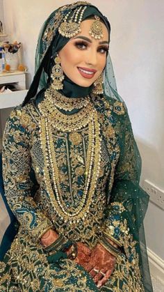 a woman in a green and gold wedding outfit