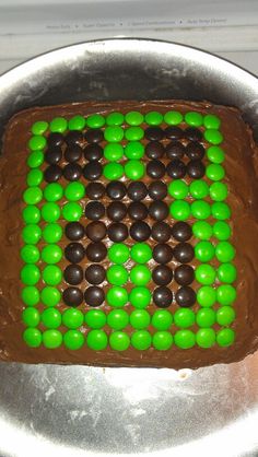 a cake decorated with chocolate and green candies